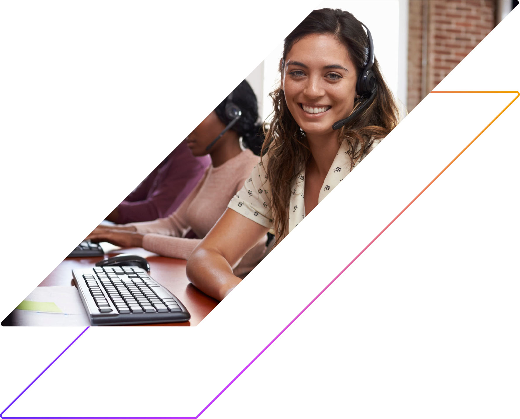 photo of a young woman smiling and working at a computer